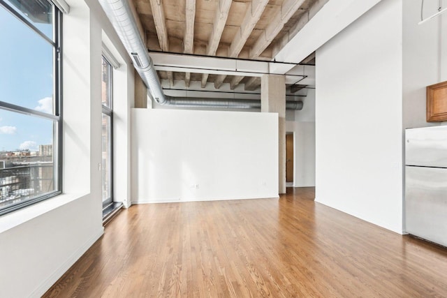 1645 W Ogden Ave Unit 516, Chicago, IL 60612 - spare room with wood finished floors and a towering ceiling