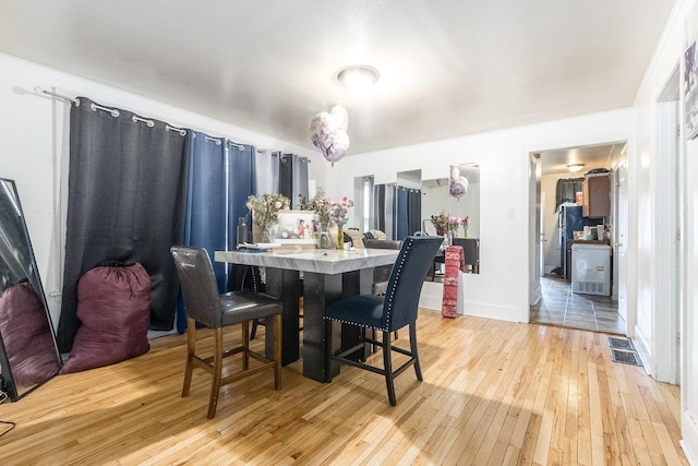 8011 S Ada St, Chicago, IL 60620 - dining area featuring light wood-style flooring and baseboards