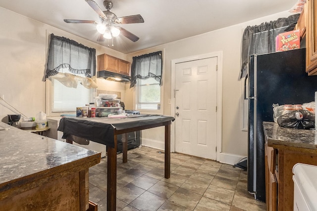 8011 S Ada St, Chicago, IL 60620 - kitchen with a ceiling fan, brown cabinetry, freestanding refrigerator, and dark countertops