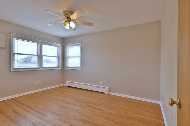 7321 W Fullerton Ave Unit 10, Elmwood Park, IL 60707 - unfurnished room featuring a baseboard radiator, light wood-type flooring, ceiling fan, and baseboards