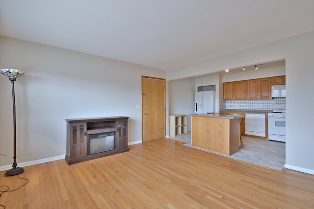 7321 W Fullerton Ave Unit 10, Elmwood Park, IL 60707 - kitchen with white appliances, light wood finished floors, a center island, decorative backsplash, and baseboards