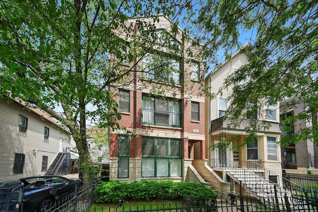 3353 N Kenmore Ave Unit 1, Chicago, IL 60657 - multi unit property with a fenced front yard, stairway, and brick siding