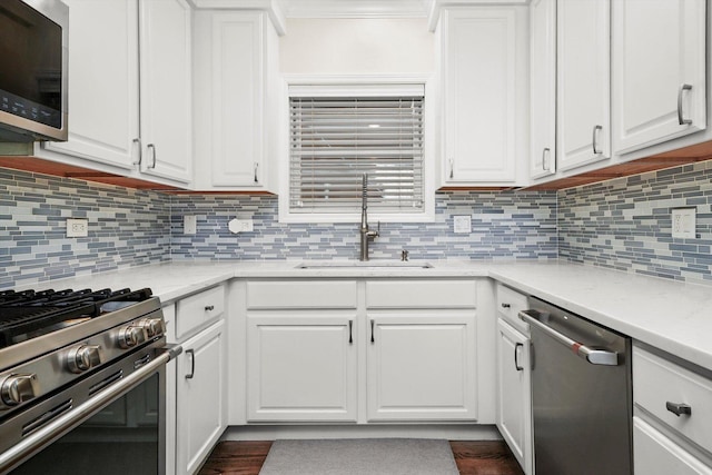 3353 N Kenmore Ave Unit 1, Chicago, IL 60657 - kitchen featuring appliances with stainless steel finishes, white cabinets, tasteful backsplash, and crown molding