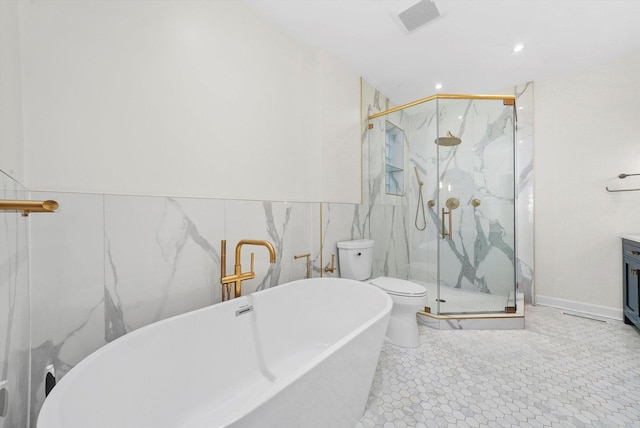 3353 N Kenmore Ave Unit 1, Chicago, IL 60657 - bathroom with a freestanding bath, a marble finish shower, tile walls, vanity, and recessed lighting