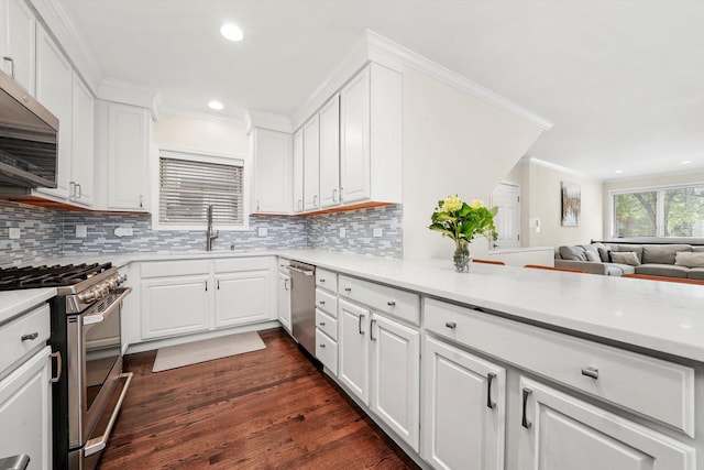 3353 N Kenmore Ave Unit 1, Chicago, IL 60657 - kitchen with appliances with stainless steel finishes, white cabinetry, open floor plan, dark wood-style flooring, and tasteful backsplash