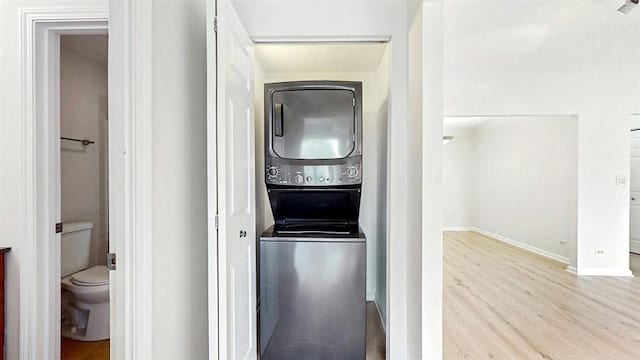 12900 W Heiden Cir Unit 4301, Lake Bluff, IL 60044 - washroom with stacked washing machine and dryer and wood finished floors