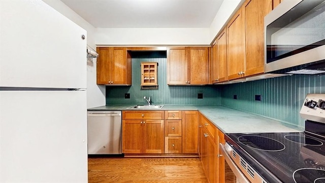 12900 W Heiden Cir Unit 4301, Lake Bluff, IL 60044 - kitchen featuring stainless steel appliances, brown cabinetry, light countertops, and light wood finished floors