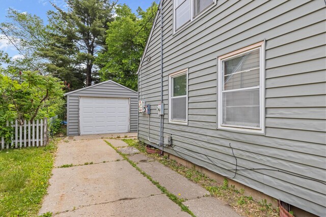 2611 Ellen St, Rockford, IL 61101 - view of side of home featuring concrete driveway, a garage, and an outbuilding