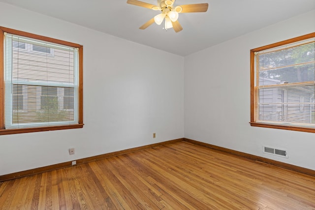 2611 Ellen St, Rockford, IL 61101 - spare room with light wood-style flooring, baseboards, healthy amount of natural light, and a ceiling fan