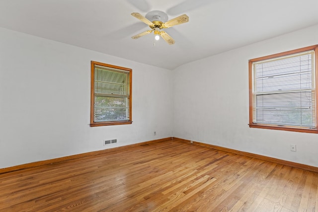 2611 Ellen St, Rockford, IL 61101 - unfurnished room featuring healthy amount of natural light, light wood finished floors, baseboards, and ceiling fan
