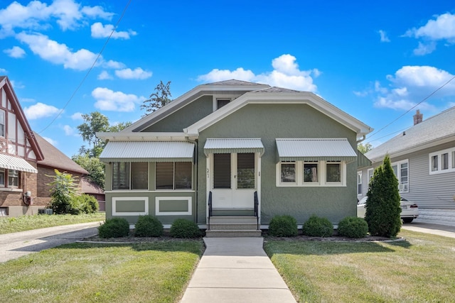 371 Elm St, Elgin, IL 60123 - bungalow-style house with a front lawn, stucco siding, and entry steps