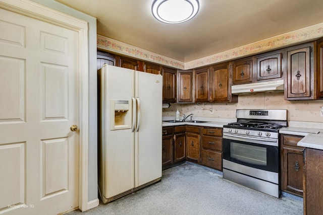 371 Elm St, Elgin, IL 60123 - kitchen with white refrigerator with ice dispenser, gas stove, under cabinet range hood, and light countertops