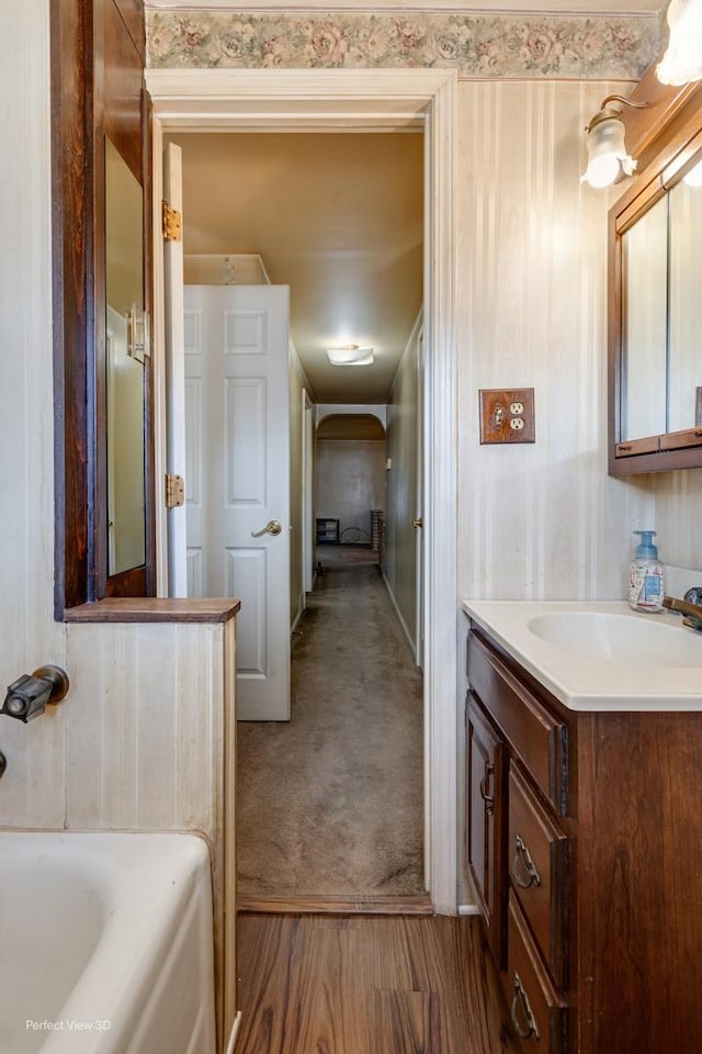 371 Elm St, Elgin, IL 60123 - bathroom with vanity, a tub to relax in, and wood finished floors