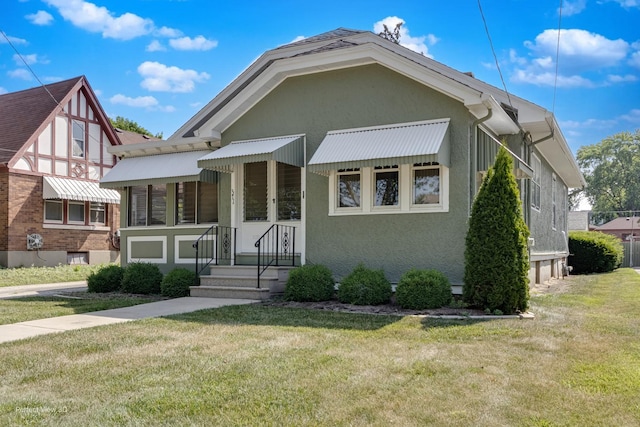371 Elm St, Elgin, IL 60123 - view of front of home with a front yard and stucco siding
