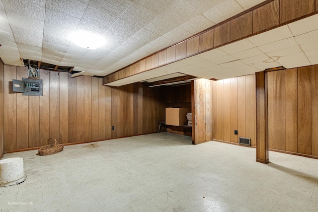 371 Elm St, Elgin, IL 60123 - finished basement with tile patterned floors, wood walls, and electric panel
