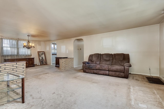 371 Elm St, Elgin, IL 60123 - living room with arched walkways, a chandelier, and light colored carpet