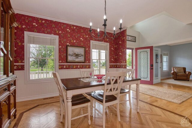 141 Mary Hamsmith Ct, Sycamore, IL 60178 - dining area with plenty of natural light, a wainscoted wall, a chandelier, wallpapered walls, and baseboards