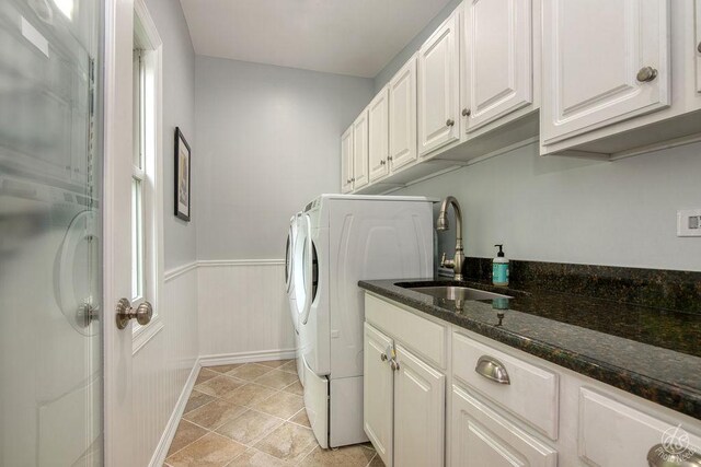 141 Mary Hamsmith Ct, Sycamore, IL 60178 - laundry area featuring cabinet space, wainscoting, baseboards, washer and clothes dryer, and light tile patterned floors