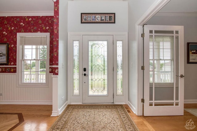 141 Mary Hamsmith Ct, Sycamore, IL 60178 - foyer with wainscoting, baseboards, parquet floors, wallpapered walls, and crown molding