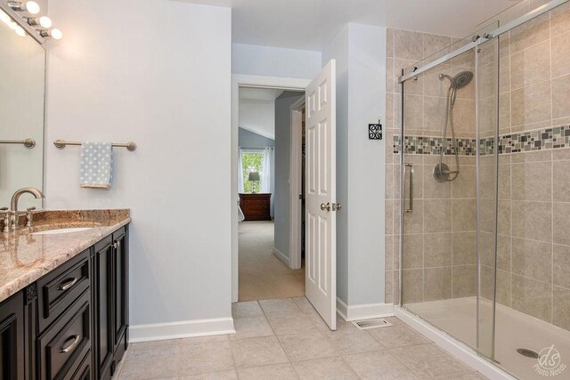 141 Mary Hamsmith Ct, Sycamore, IL 60178 - bathroom featuring vanity, a shower stall, vaulted ceiling, and baseboards