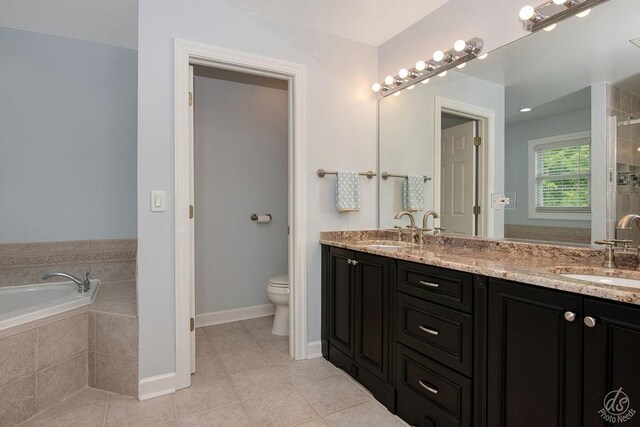 141 Mary Hamsmith Ct, Sycamore, IL 60178 - bathroom with double vanity, a garden tub, toilet, tile patterned flooring, and baseboards