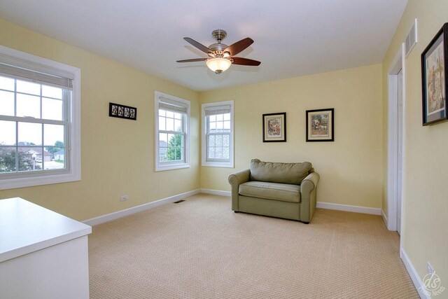 141 Mary Hamsmith Ct, Sycamore, IL 60178 - living area featuring light colored carpet, baseboards, and a ceiling fan