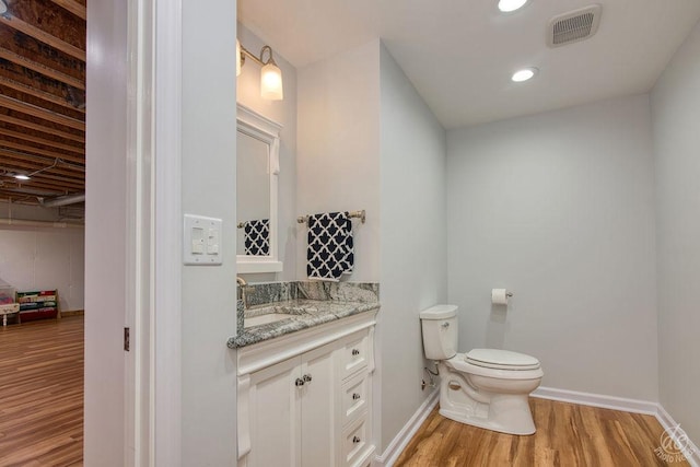 141 Mary Hamsmith Ct, Sycamore, IL 60178 - half bath with wood finished floors, vanity, toilet, baseboards, and recessed lighting