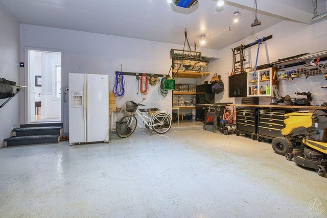141 Mary Hamsmith Ct, Sycamore, IL 60178 - garage with white fridge with ice dispenser, a workshop area, and a garage door opener