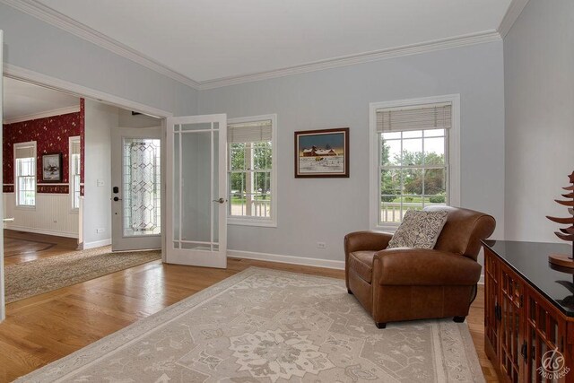 141 Mary Hamsmith Ct, Sycamore, IL 60178 - living area with wood finished floors, ornamental molding, healthy amount of natural light, and baseboards