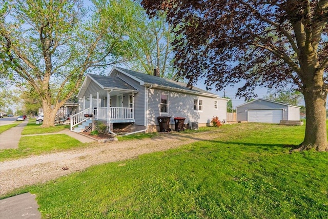 800 E Webster St, Clinton, IL 61727 - view of front facade with covered porch, a garage, a front yard, a chimney, and an outdoor structure