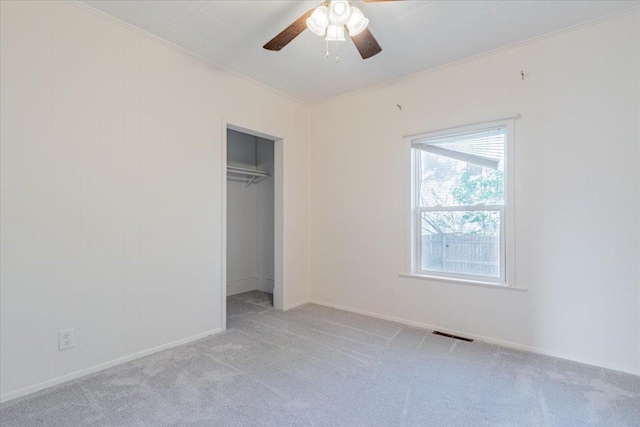 800 E Webster St, Clinton, IL 61727 - unfurnished bedroom with light carpet, a closet, baseboards, and ceiling fan
