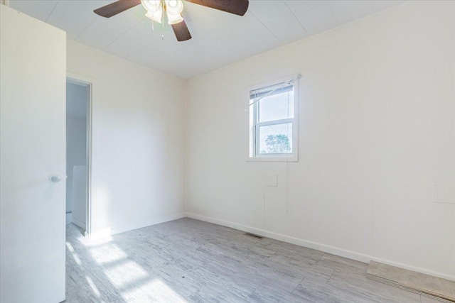 800 E Webster St, Clinton, IL 61727 - unfurnished room with ceiling fan, wood finished floors, and baseboards