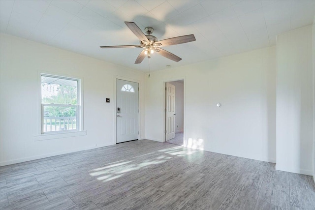 800 E Webster St, Clinton, IL 61727 - unfurnished room with wood finished floors, ceiling fan, and baseboards