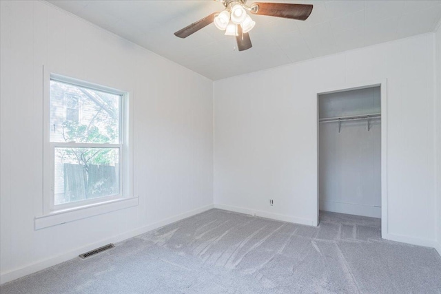 800 E Webster St, Clinton, IL 61727 - unfurnished bedroom featuring carpet flooring, a closet, baseboards, and a ceiling fan
