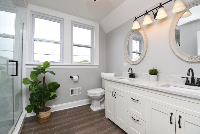 1234 Edmer Ave, Oak Park, IL 60302 - full bath with vaulted ceiling, double vanity, a shower stall, and wood finished floors