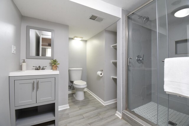 1234 Edmer Ave, Oak Park, IL 60302 - bathroom featuring a shower stall, vanity, and wood finished floors