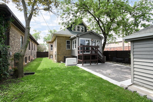 1234 Edmer Ave, Oak Park, IL 60302 - back of property with a fenced backyard, brick siding, a patio area, and a wooden deck