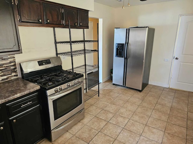 3014 W 163rd St, Markham, IL 60428 - kitchen featuring appliances with stainless steel finishes, decorative backsplash, light tile patterned flooring, baseboards, and dark countertops