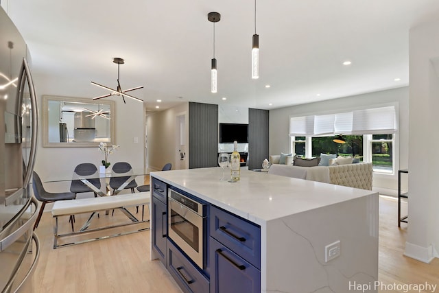 539 S Plum Grove Rd, Palatine, IL 60067 - kitchen featuring appliances with stainless steel finishes, light wood finished floors, a ceiling fan, blue cabinetry, and recessed lighting