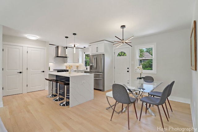 539 S Plum Grove Rd, Palatine, IL 60067 - kitchen featuring stainless steel fridge, wall chimney exhaust hood, healthy amount of natural light, and a center island