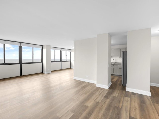 4850 S Lake Park Ave Unit 2508B, Chicago, IL 60615 - unfurnished living room featuring wood finished floors and baseboards