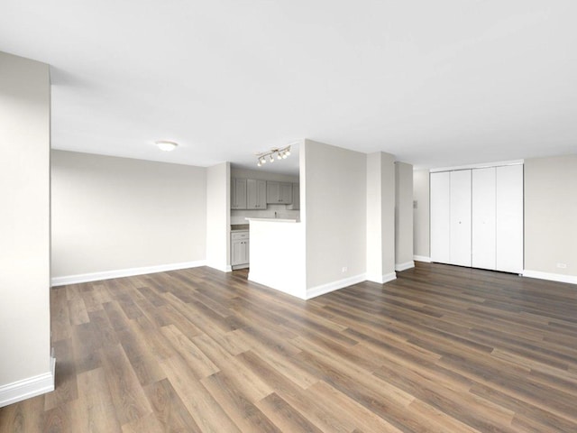 4850 S Lake Park Ave Unit 2508B, Chicago, IL 60615 - unfurnished living room with dark wood-style flooring and rail lighting