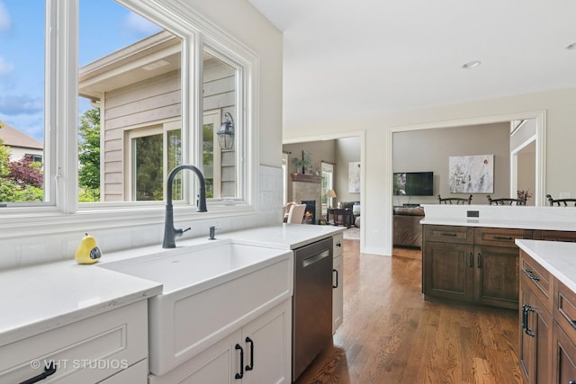 76 Landon Cir, Wheaton, IL 60189 - kitchen featuring dishwasher, healthy amount of natural light, a warm lit fireplace, light countertops, and recessed lighting