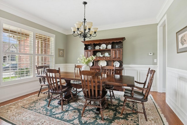 76 Landon Cir, Wheaton, IL 60189 - dining room with healthy amount of natural light, a chandelier, ornamental molding, light wood finished floors, and wainscoting