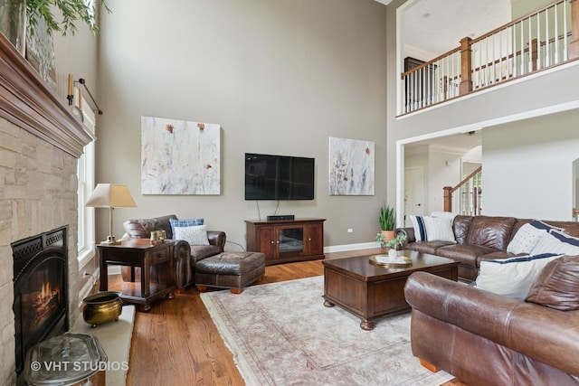 76 Landon Cir, Wheaton, IL 60189 - living room featuring a towering ceiling, a stone fireplace, and wood finished floors