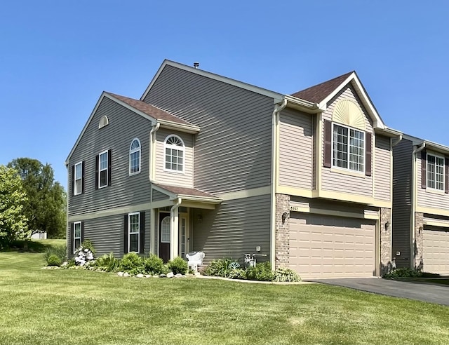 6941 Brightwater Dr, Fox Lake, IL 60020 - view of front facade featuring an attached garage, asphalt driveway, and a front lawn