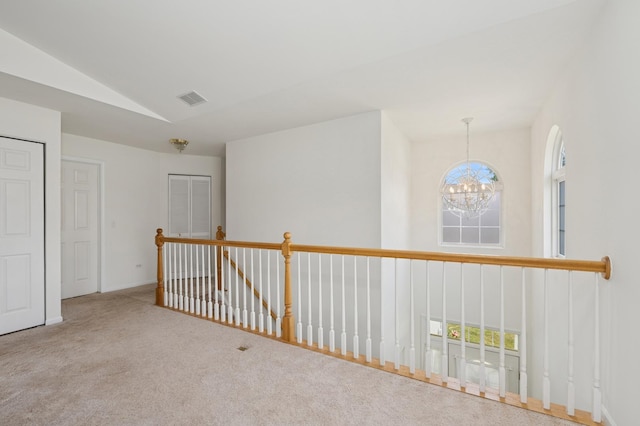 6941 Brightwater Dr, Fox Lake, IL 60020 - hall featuring a chandelier, vaulted ceiling, carpet floors, and an upstairs landing
