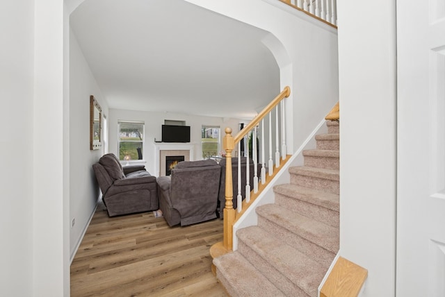 6941 Brightwater Dr, Fox Lake, IL 60020 - stairs featuring wood finished floors, a fireplace, and arched walkways