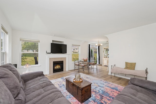 6941 Brightwater Dr, Fox Lake, IL 60020 - living area featuring a chandelier, light wood finished floors, and a tiled fireplace