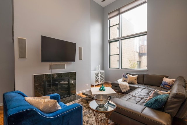 2943 N Lincoln Ave Unit 201, Chicago, IL 60657 - living room with wood finished floors, baseboards, a tile fireplace, and a towering ceiling